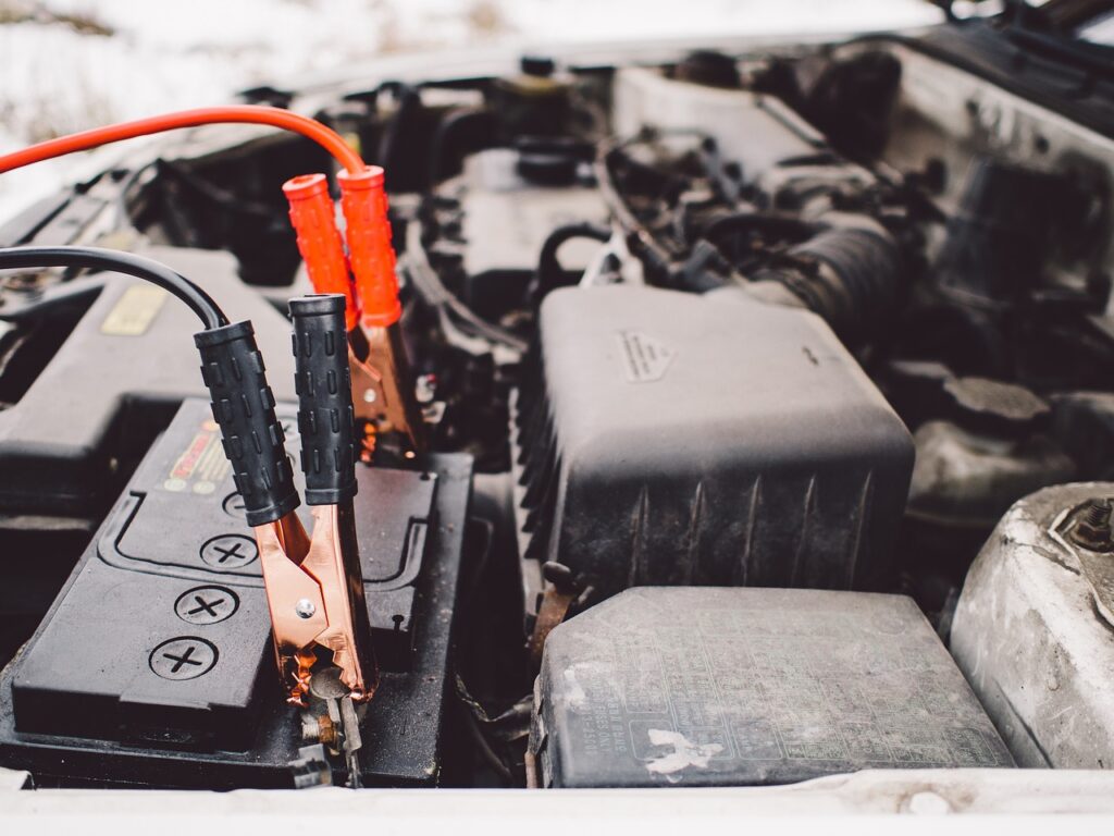 A car battery with wires attached, located in Dandenong, ready for use or installation.